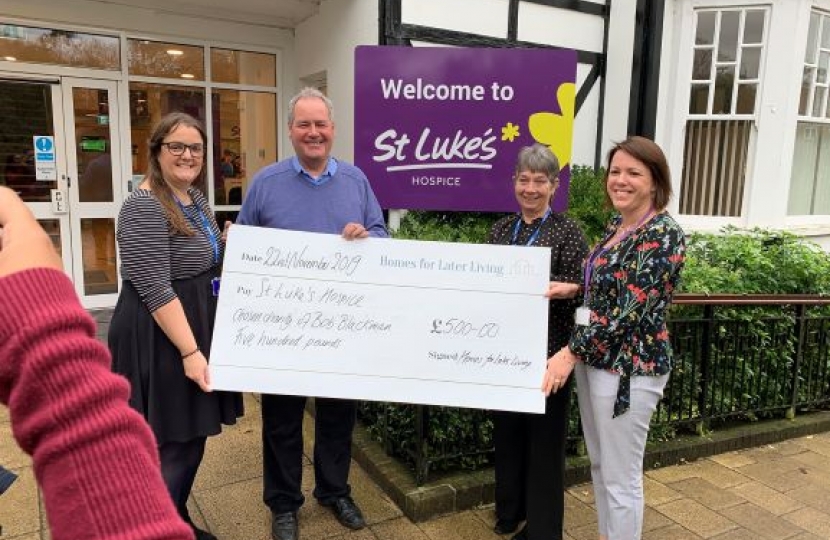 Bob delivers £500 cheque to St Luke's Hospice