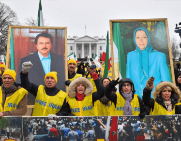 Demonstrations hold portraits of Iranian politicians Massoud Rajavii and his wife, Maryam Rajavi, at a rally help by the Organization of Iranian-American Communities